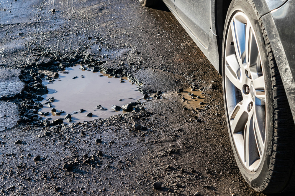 Car,wheel,close Up,near,a,pothole,on,the,road.,broken
